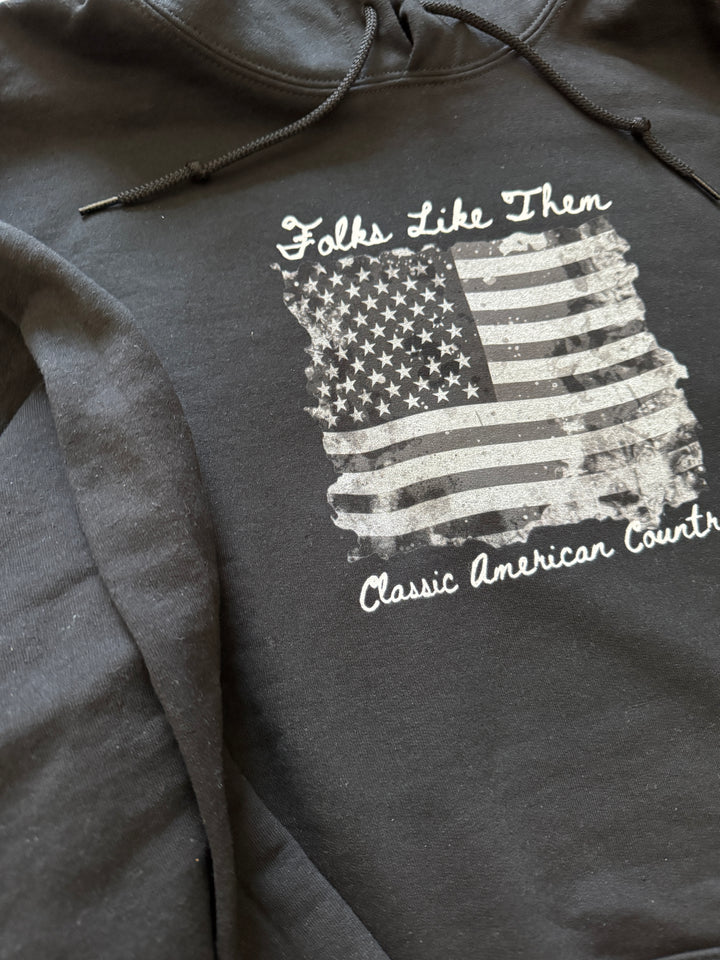 Black hoodie featuring an artistic American flag design and 'Classic American Country' text, highlighting a blend of style and patriotism.